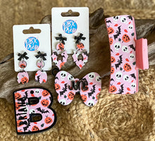 Pink Halloween Hair Claw with friendly bats, pumpkins, and skulls on a pastel pink background – handmade in the Outer Banks
