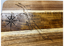 Close-up of Outer Banks engraved wood tray showing coastal town map and sailboat detail